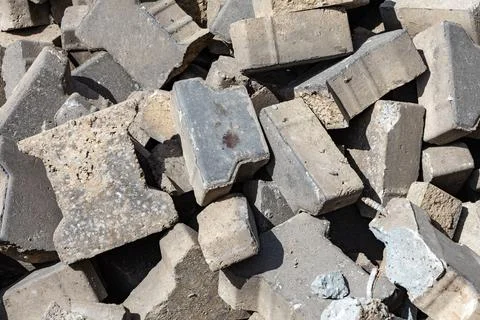 Pile of gray concrete bricks on a construction site during daylight hours Stock Photos