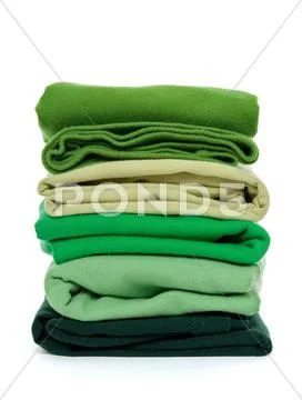 Pile of green folded clothes Stock Photos