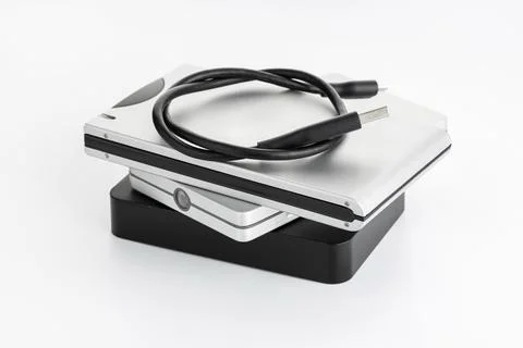 Pile of a group of external Hard disk drive on white table. HDD Data storage Stock Photos