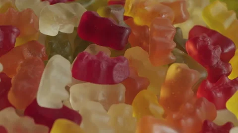 Pile of gummy bear candy background rotating macro. Unhealthy food concept Stock Footage 283871057