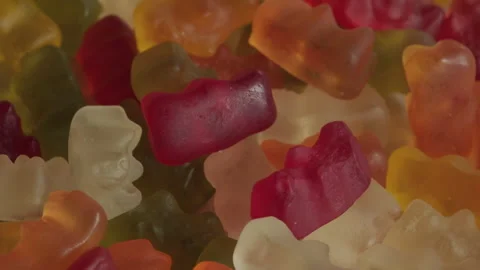 Pile of gummy bear candy background rotating macro. Unhealthy food concept Stock Footage 283871213