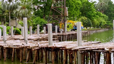 Pile hammer working on construction site. The walkway is being built by the pool Stock Footage 171798097