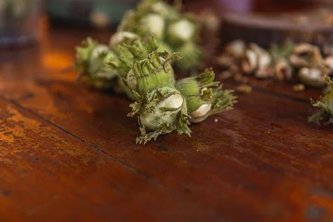 A pile of hazelnuts on a table outside Stock Photos