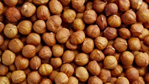 Pile of hazelnuts without shell rotating. Texture of hazelnut kernels. Video stock 293948677