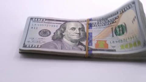 A pile of hundred-dollar bills falling onto a table. Close up Stock Footage 319627461