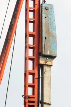 Pile installation by drop hammer. Stock Photos