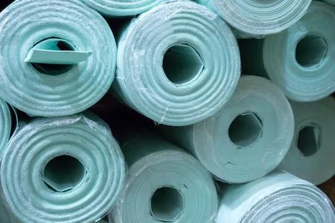 Pile of insulation material rolls. Light green or blue color. Filled frame. Stock Photos