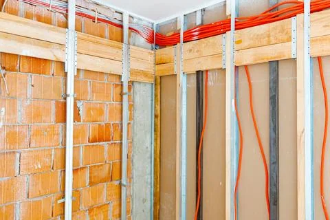 Pile of isolated cables hangs on the wall with metal and wood frame for pla.. Stock Photos