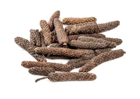 Pile of java long pepper catkins closeup on white Photos