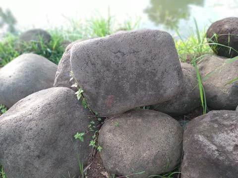 A pile of large rocks with a smooth texture and gray color 写真素材