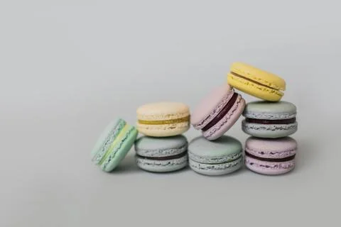Pile of macaroon or macaron biscuits on grey background. Stock Photos