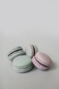 Pile of macaroon or macaron biscuits on grey background. Stock Photos