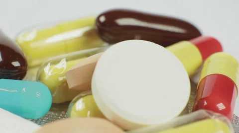 Pile of many different pills on white background, macro closeup rotation Stock Footage 53789938