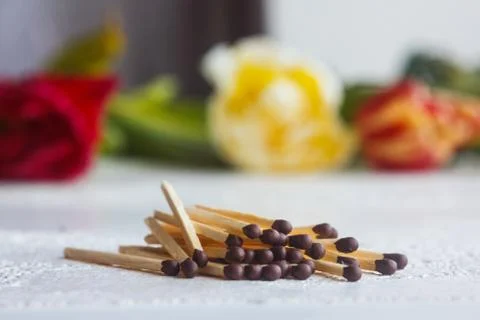 A pile of matches close up on a white table. Macro fire igniter on blurred ba Stock Photos