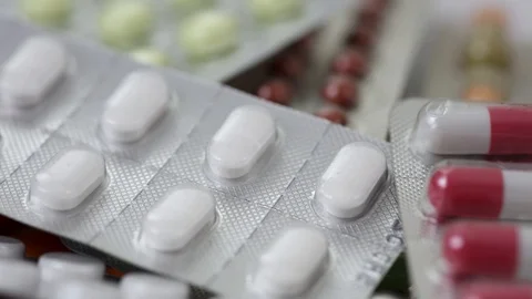 Pile of medication pills in blisters rotating in a seamless loop Stock Footage 123002359