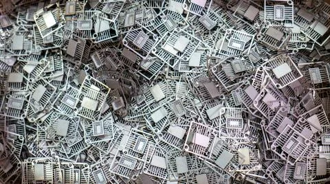 Pile of Metallic Semiconductor Lead Frames and Integrated Circuits Stock-Fotos