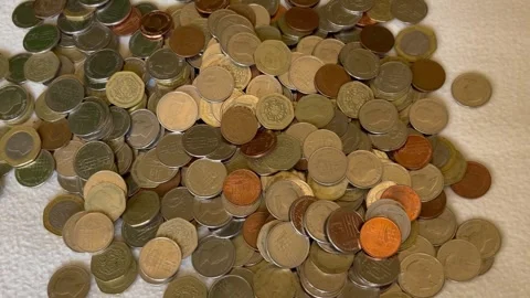 Pile of Mixed Coins Falling onto White Background Stock Footage 345305826