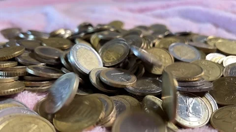 Pile of money into which coins fall Stock Footage 221784625