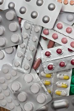 A pile of multi-colored pills lie one on one Stock Photos