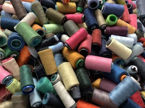 Pile of multi-colored spools of thread close-up Stock Photos
