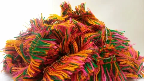 A pile of multicolored thread strands rotating on white background close up.. Stock Footage 282095771