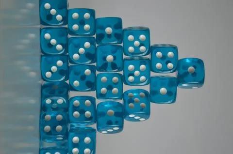 Pile of multiple blue plastic arcylic d6 six sided die dice variable focus Foto stock