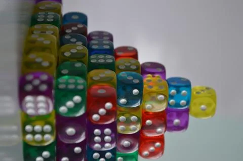 Pile of multiple coloured plastic arcylic d6 six sided die dice variable focus Foto stock