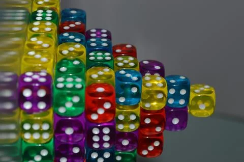 Pile of multiple coloured plastic arcylic d6 six sided die dice variable focus Foto stock