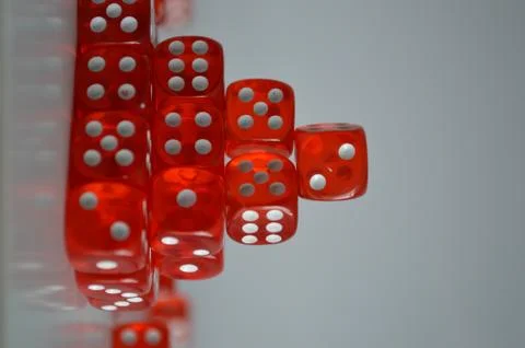 Pile of multiple red plastic arcylic d6 six sided die dice variable focus Stockfoto's