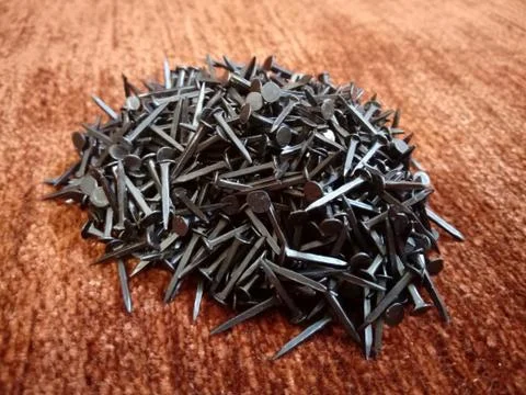 Pile of nails on red background Stock Photos