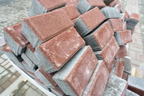 Pile of new clean construction bricks in a haphazard disordered arrangement.  Stock Photos