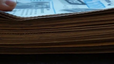 A pile of newspapers Vídeos de archivo 115991034