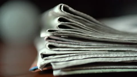 A pile of Newspapers on a table Stock Footage 235275598