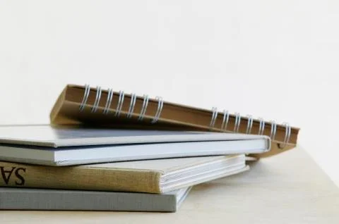 Pile of note books close up studio shot Stock Photos