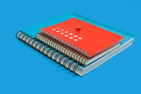 Pile of notebooks on a blue background Stock Photos