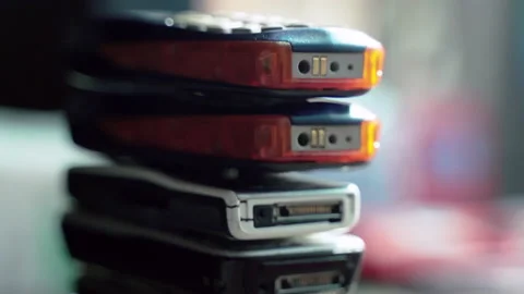 A pile of old and outdated colorful cell phones, used and broken mobile phones 库存影片 131194462