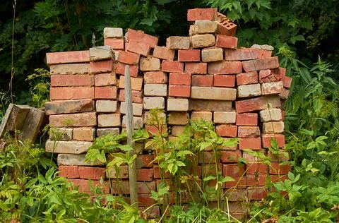 Pile old bricks are stacked in the grass Stock Photos