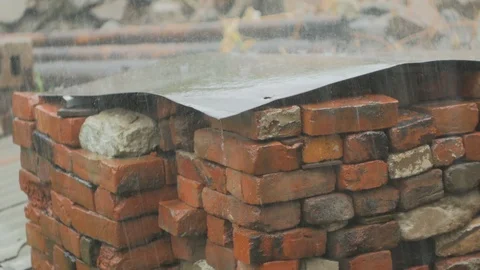 A pile of old bricks is flooded with heavy rain 스톡 동영상 92288878