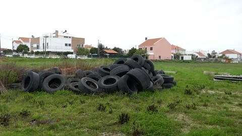 Pile of old rubber tyres in a green field. Stack abandoned car wheels Stock Footage 150970341