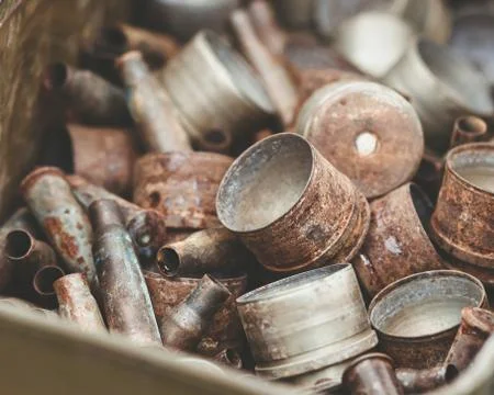 Pile of old rusty shell casings from assault rifles and mounted grenade launc Stock Photos
