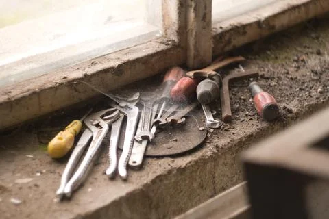 Pile of old tools sitting on a window Stock Photos