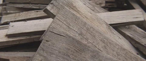 Pile of old used planks anamorphic 5.7K tilting video Stock Footage 304573665