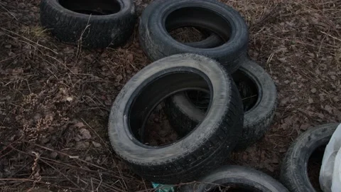 Pile of old worn tire in forest Stock Footage 130867946