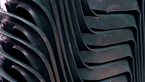 Pile or stack of dark green chairs Stock Footage 116626918