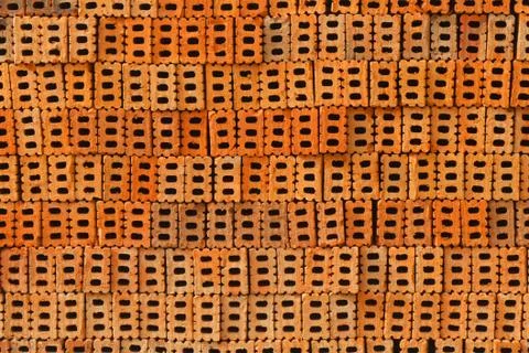 Pile of orange bricks for pattern and construction Stock Photos