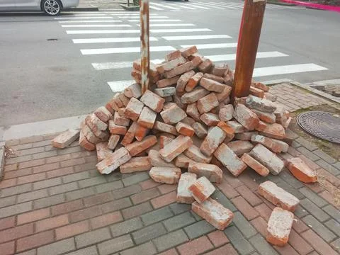 A pile of orange bricks is on the sidewalk Stock Photos