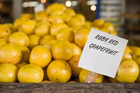 Pile of orange ruby grapefruit on the wooden table in the market. 写真素材