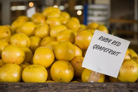 Pile of orange ruby grapefruit on the wooden table in the market. Fruit harve Stock Photos