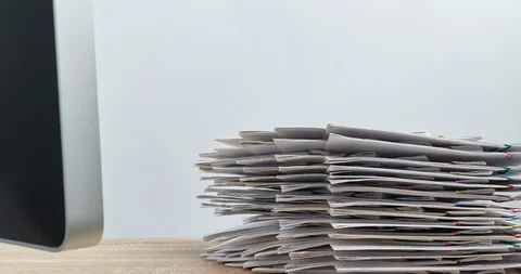 Pile overload document with computer on wood table time lapse 動画素材 112965575