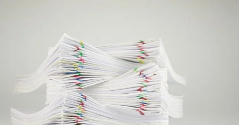 Pile overload document of report on white background time lapse 動画素材 68857281